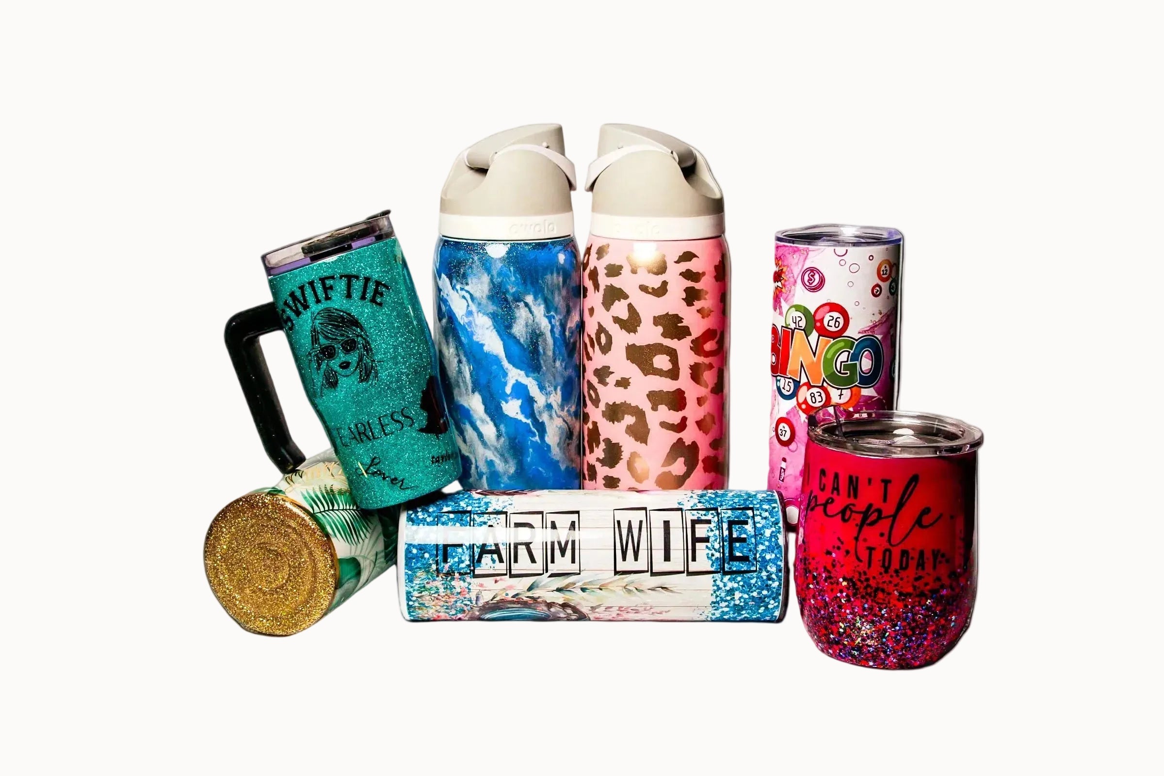 Collection of colorful tumblers and mugs with various designs on a white background
